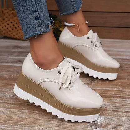 Side view of glossy white chunky platform sneakers for women, emphasizing comfort & fashion.