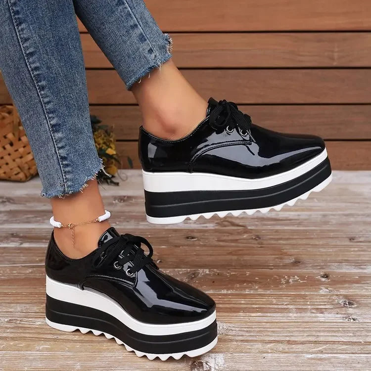 Close-up of women's glossy platform sneakers, highlighting the shiny texture & comfortable sole.