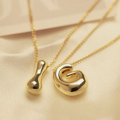 Close-up: Women's Golden Pop initial pendant, a chic personalized gold-tone letter necklace for daily style.