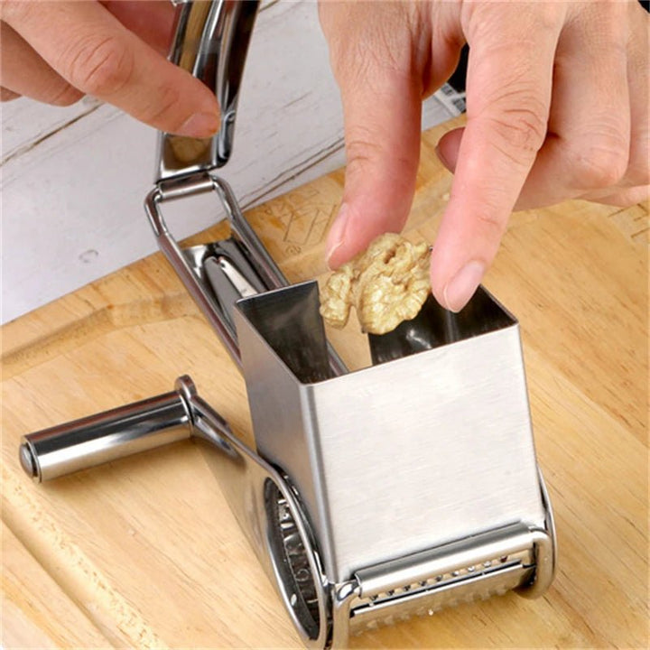 Close-up of GRATE MOTION rotary grater, showing sharp stainless steel drum for perfect shredding.