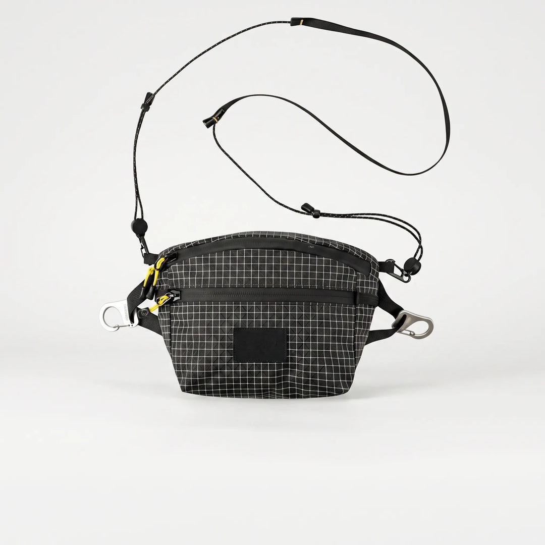 Versatile gray sling bag with grid pattern, perfect for daily carry, travel, and outdoor gear.