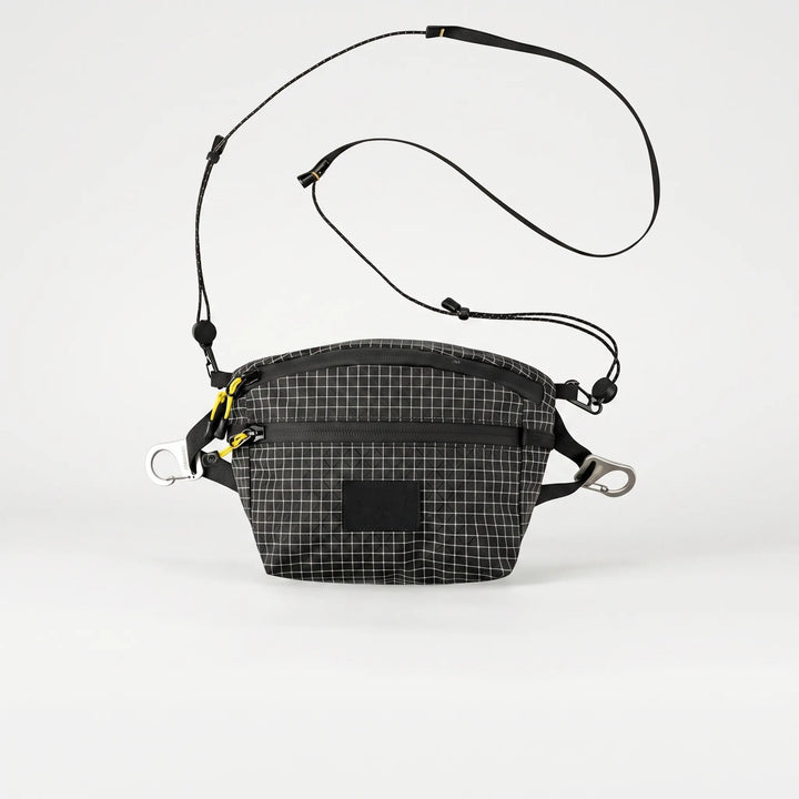 Versatile gray sling bag with grid pattern, perfect for daily carry, travel, and outdoor gear.