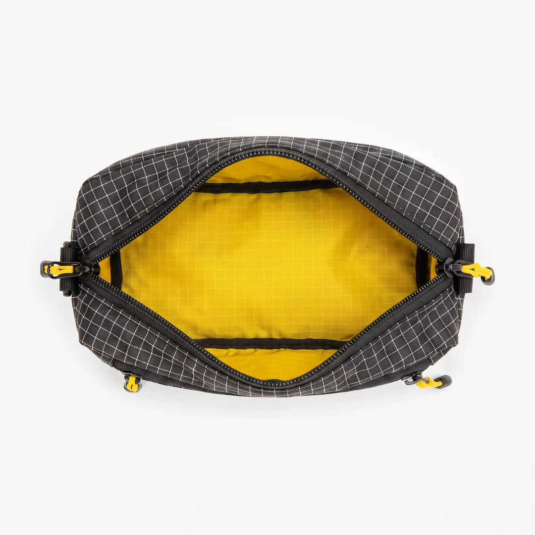 Stylish gray crossbody bag with grid pattern, suitable for travel, outdoor & daily use.