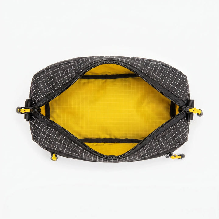 Stylish gray crossbody bag with grid pattern, suitable for travel, outdoor & daily use.