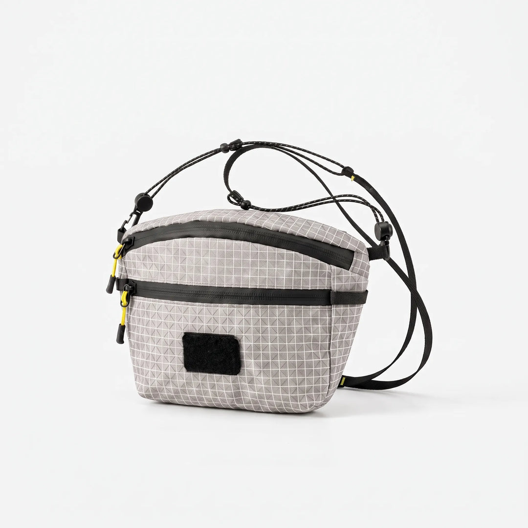 Durable gray chest bag, a versatile everyday carry sling for men and women, grid design.