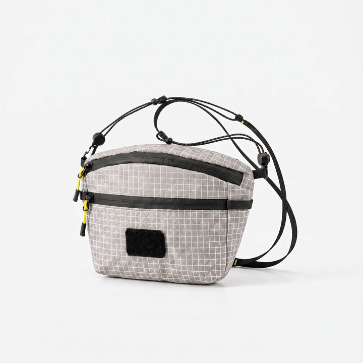 Durable gray chest bag, a versatile everyday carry sling for men and women, grid design.