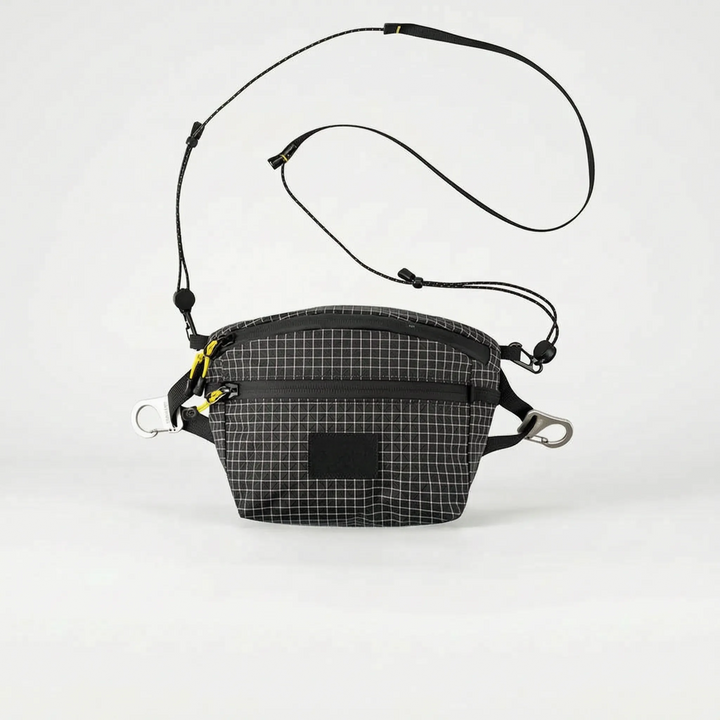Compact gray travel fanny pack, a versatile grid pattern chest bag for essentials.