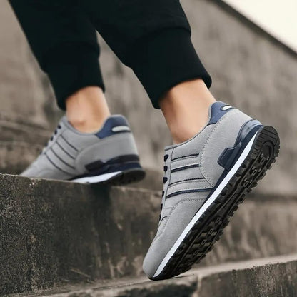 Comfortable gray lace-up women's sneakers, perfect for walking and everyday wear. Breathable and cushioned.