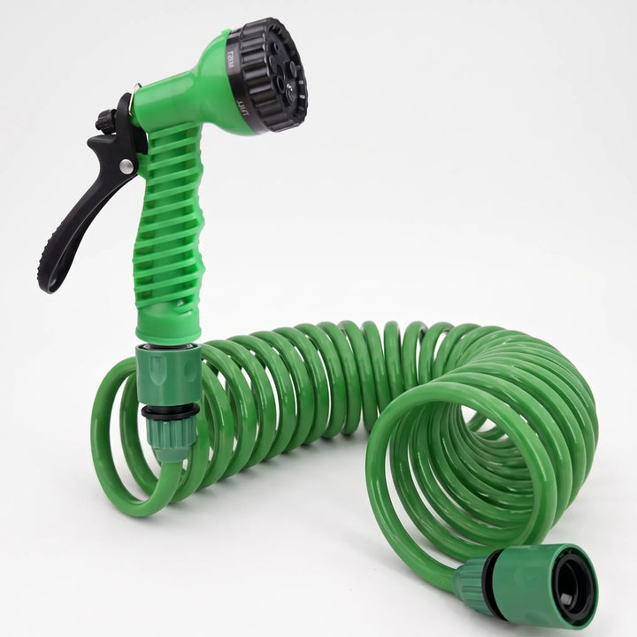 Compact green coiled garden hose, tangle-free for outdoor watering, car wash, & patio cleaning. Space-saving storage.