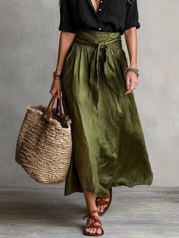 Close-up of green women's relaxed fit button-front blouse and tie-waist maxi skirt set. Versatile summer style.