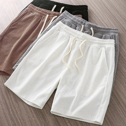 Brown unisex comfortable drawstring shorts, relaxed fit, versatile for summer, everyday outfits, or light athletic activities.