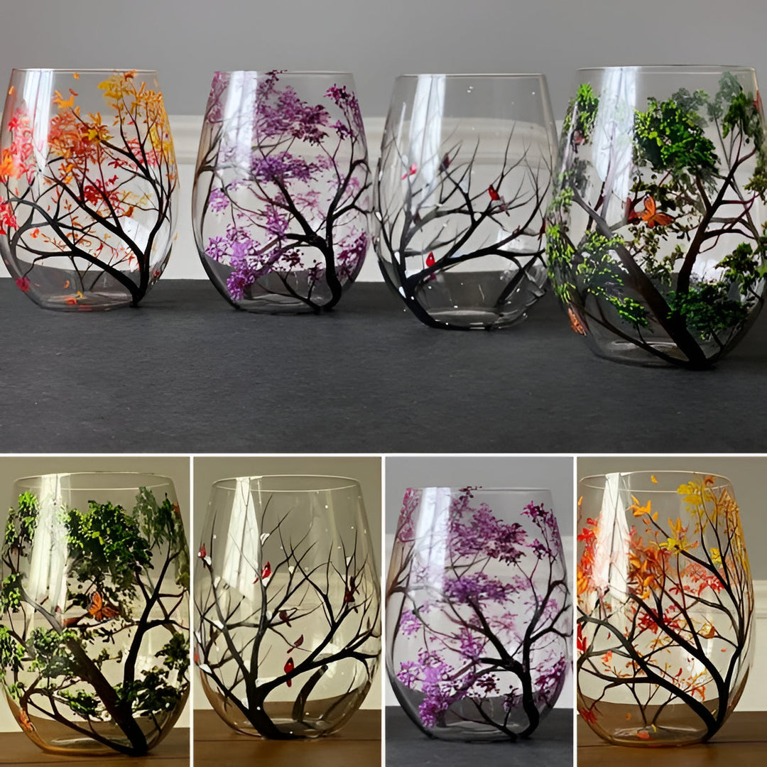 Vibrant hand painted four seasons tree design on wine glasses, unique artistic home decor.