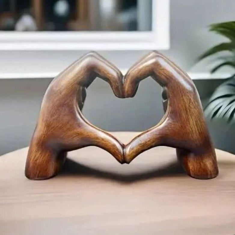 Artisanal wooden heart hands sculpture, handcrafted for rustic home decor. A unique love symbol table accent.