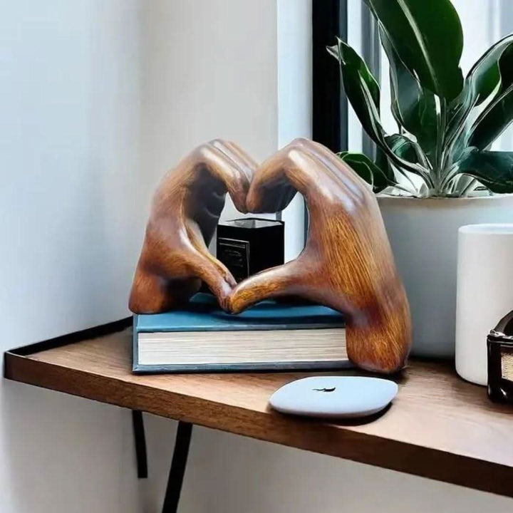 Detailed handcrafted wood sculpture depicting hands forming a heart, ideal rustic home decor & love symbol.