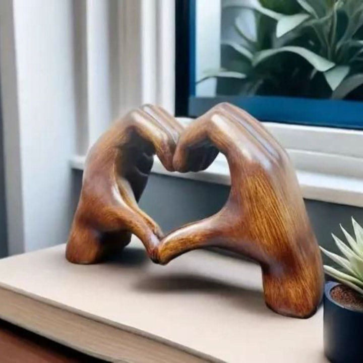 Artistic wooden heart hands figurine, a handcrafted love symbol and unique rustic home decor accent piece.
