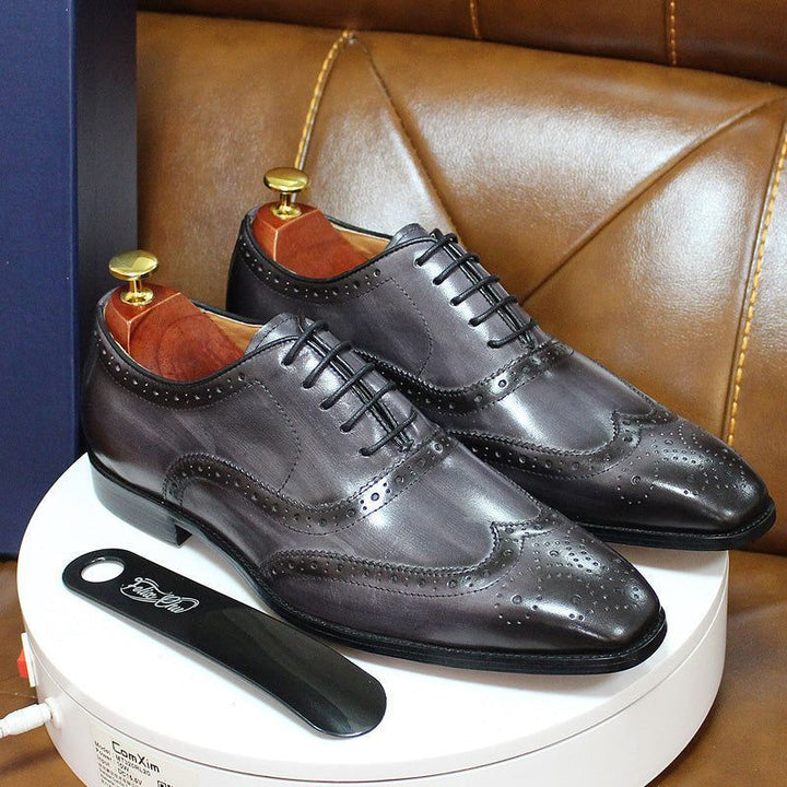 Professional men's leather Oxford dress shoes, wingtip style, ideal for business attire and formal events.