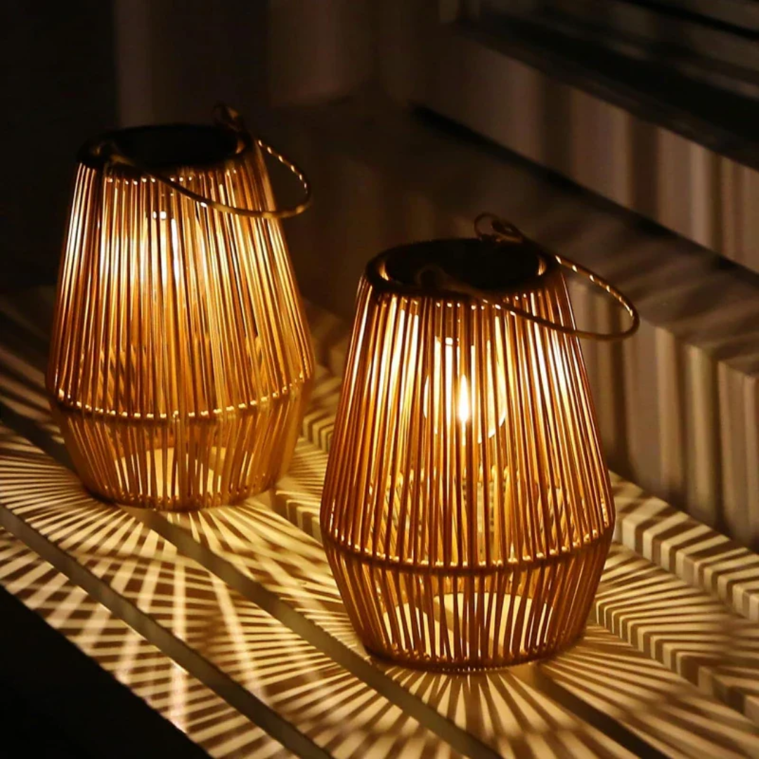 Beautiful handwoven solar lantern creating warm LED light on a garden path. Outdoor patio decor.