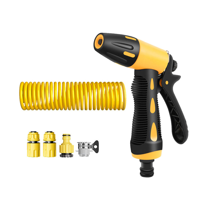 User hosing down patio with high-pressure water gun and expand-able coiled hose, effective cleaning