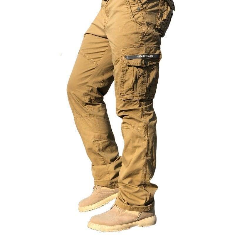 Close-up of men's olive green outdoor cargo pants fabric, showcasing reinforced stitching and pocket detail