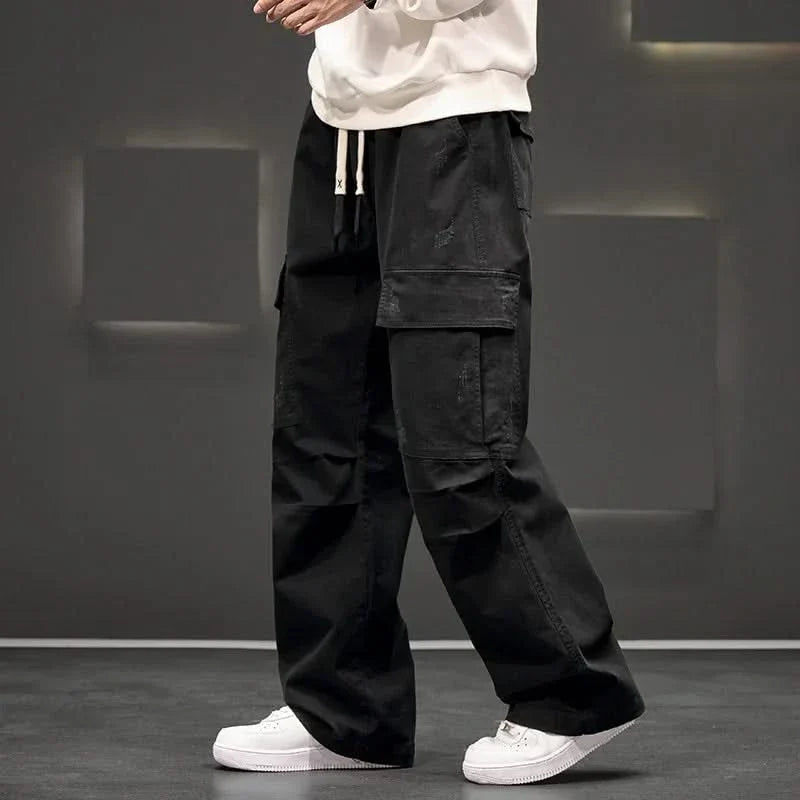 Black men's relaxed fit utility cargo pants, comfortable & versatile with multiple pockets, ideal for outdoor & casual style.