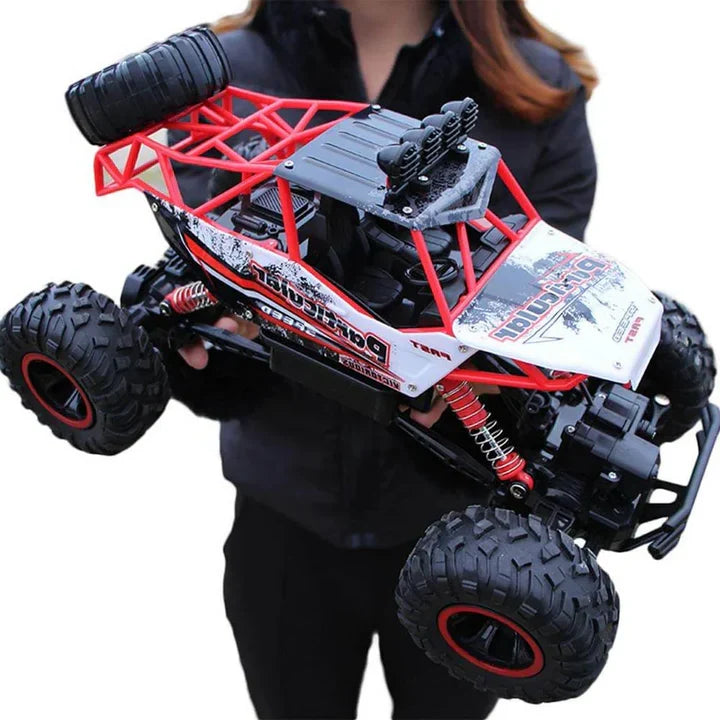 Close-up of a kids' RC off-road monster truck, showcasing its durable tires and high-speed 4WD chassis.