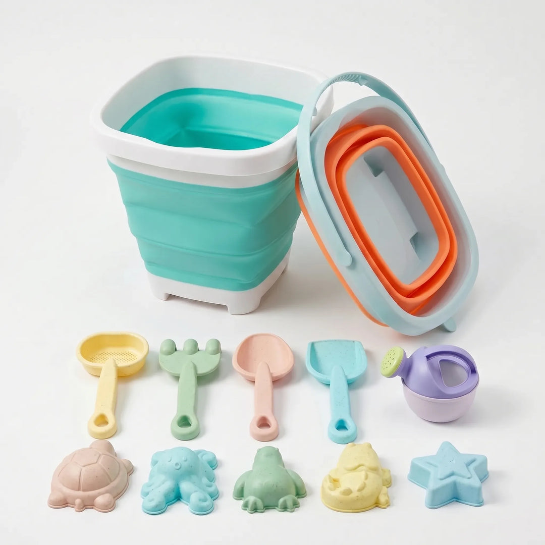 Travel-friendly kids' beach toy set with collapsible silicone bucket & plastic tools for summer sand play.