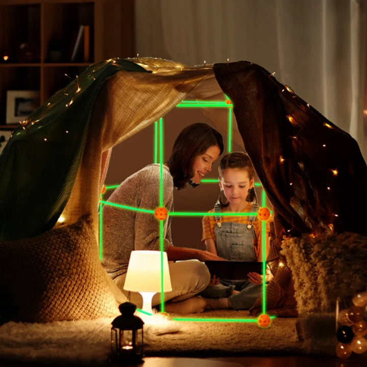 Child smiling inside a DIY fabric fort, built with a creative construction toy set for imaginative play.