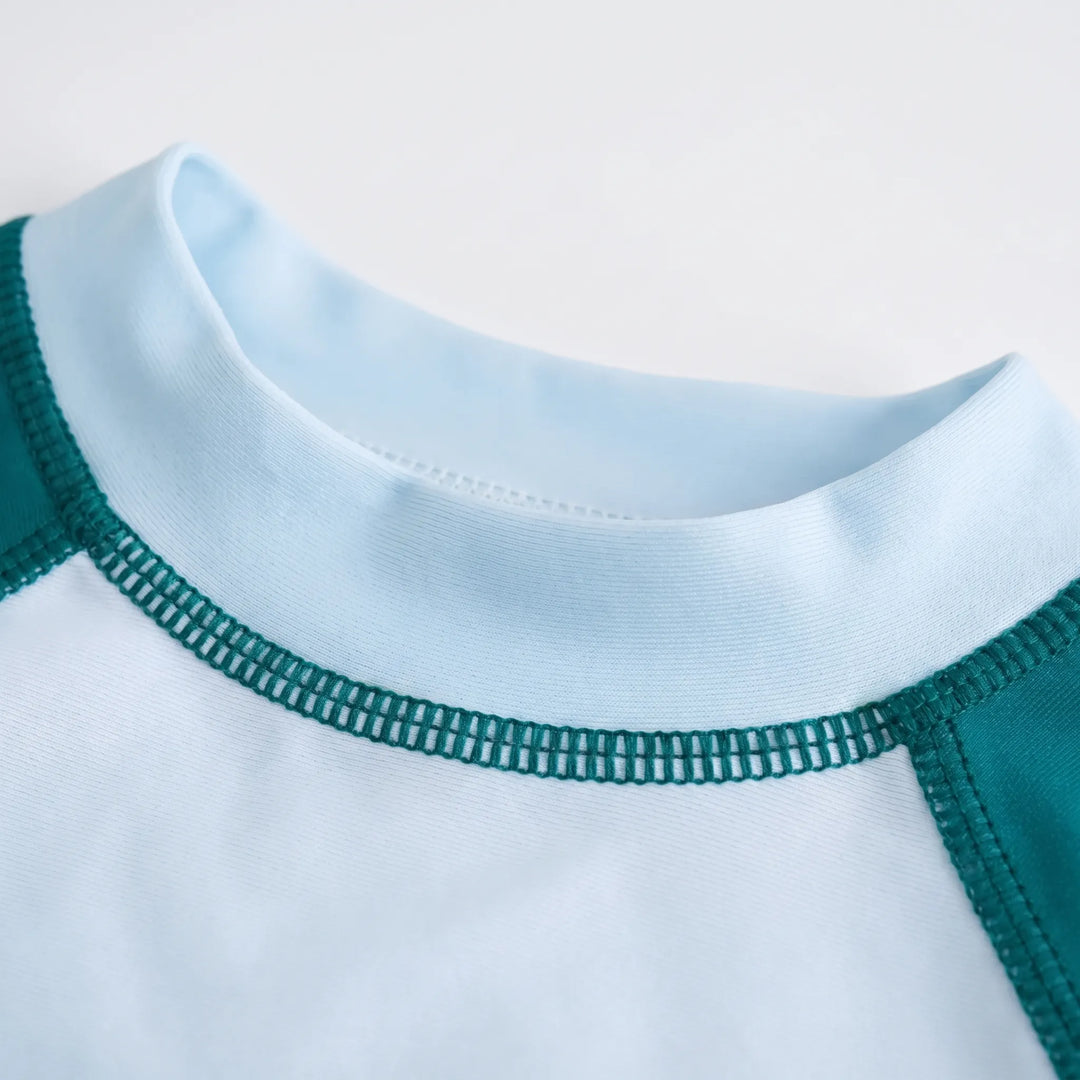 Protective kids' long sleeve swimwear set, rash guard top & bottoms for sun-safe beach play & swimming.