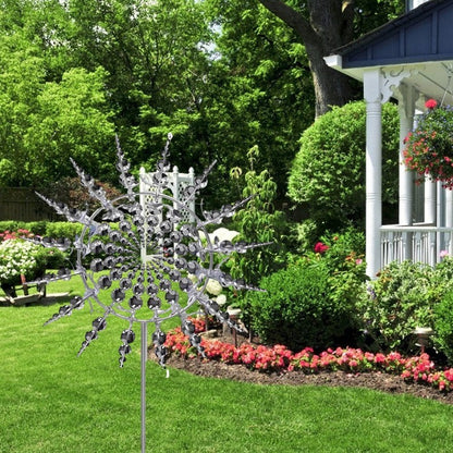 Close-up of a rust-resistant kinetic metal wind spinner, showing intricate windmill blades for garden art.