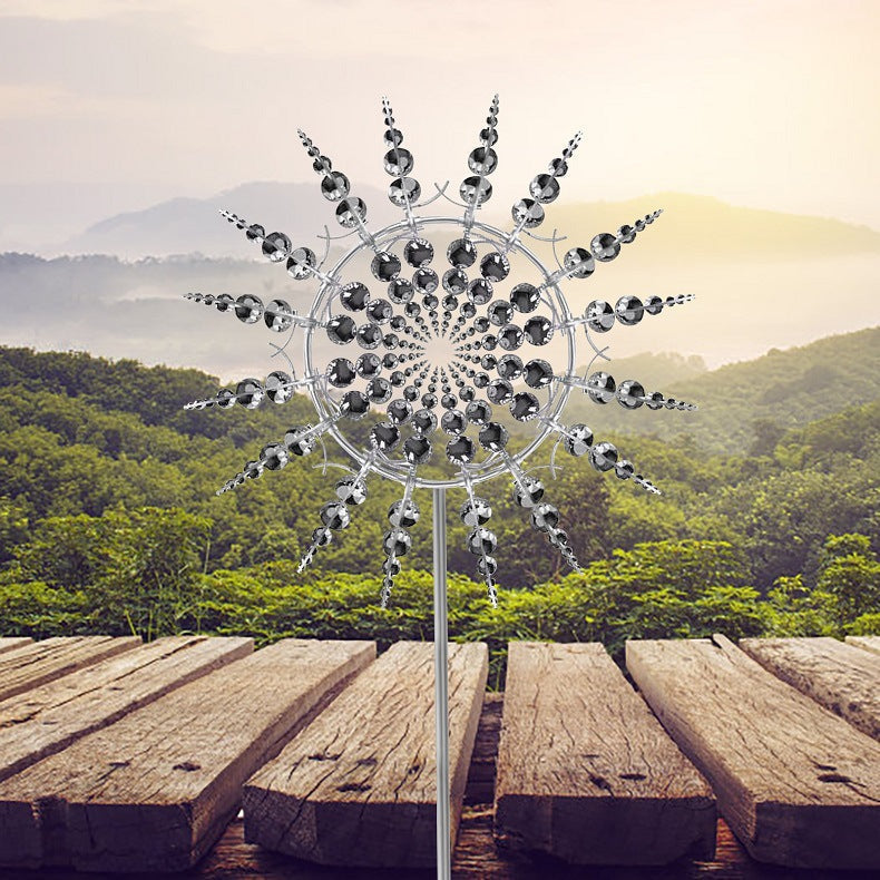 Large kinetic metal garden wind spinner, rust-resistant, standing tall amidst flowers as unique outdoor art.