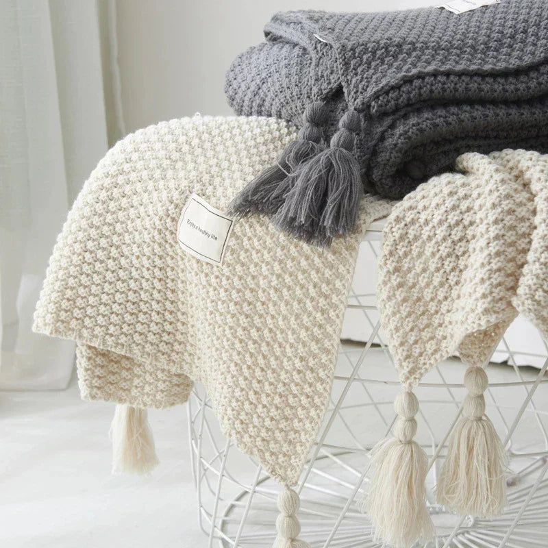 High-quality knitted wool blanket, durable yet soft, with stylish tassels for lasting comfort.