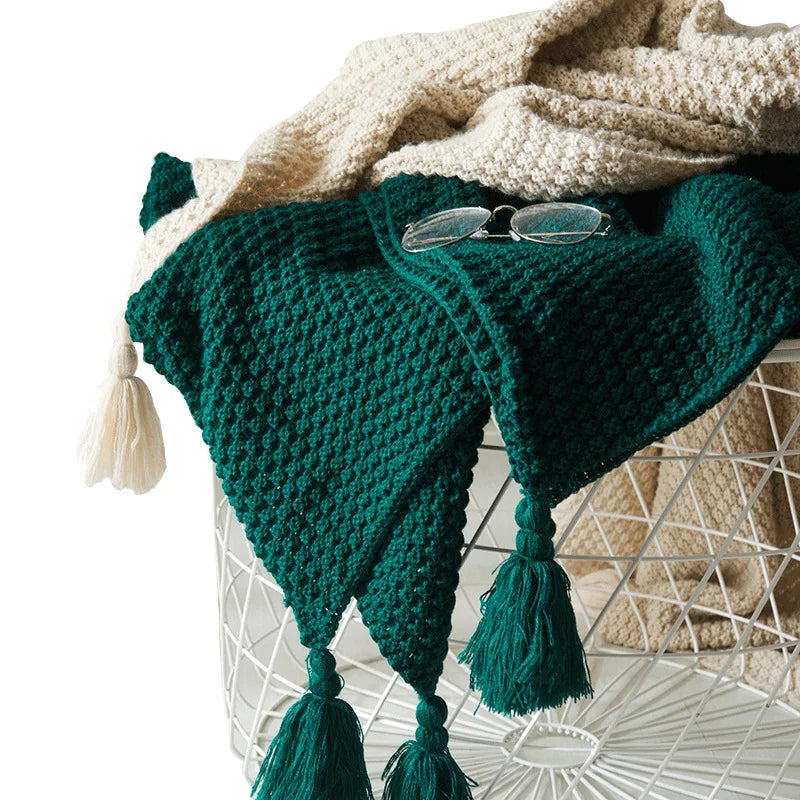 Natural wool knitted throw blanket, Scandinavian style with decorative tassels.
