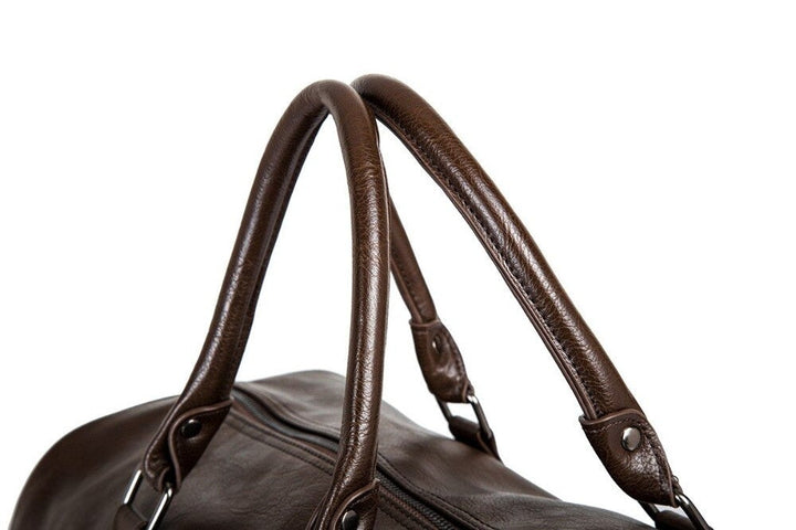 Black large capacity faux leather travel duffel. Lightweight, durable, ideal carry-on weekender bag.