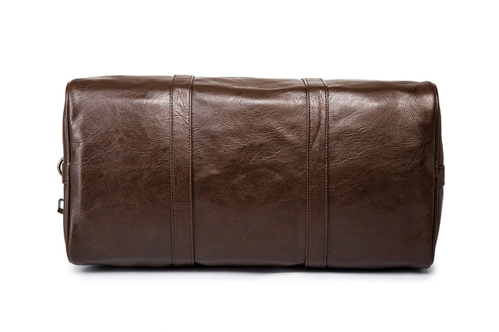 Brown lightweight faux leather gym bag. Spacious overnight duffel, perfect for unisex travel needs.