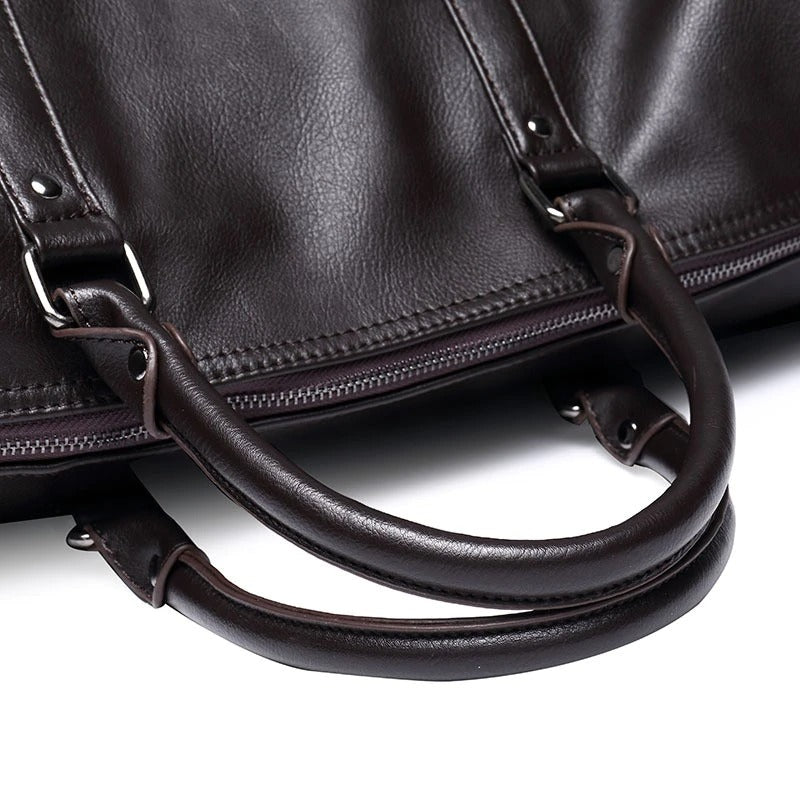 Black faux leather travel duffel. Lightweight overnight bag for men & women, spacious & stylish.