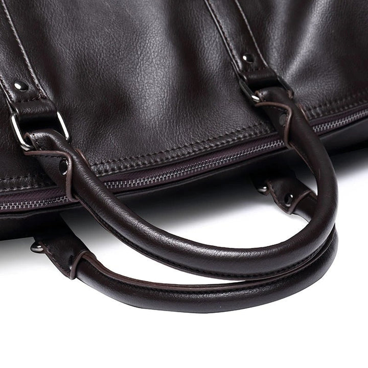 Black faux leather travel duffel. Lightweight overnight bag for men & women, spacious & stylish.