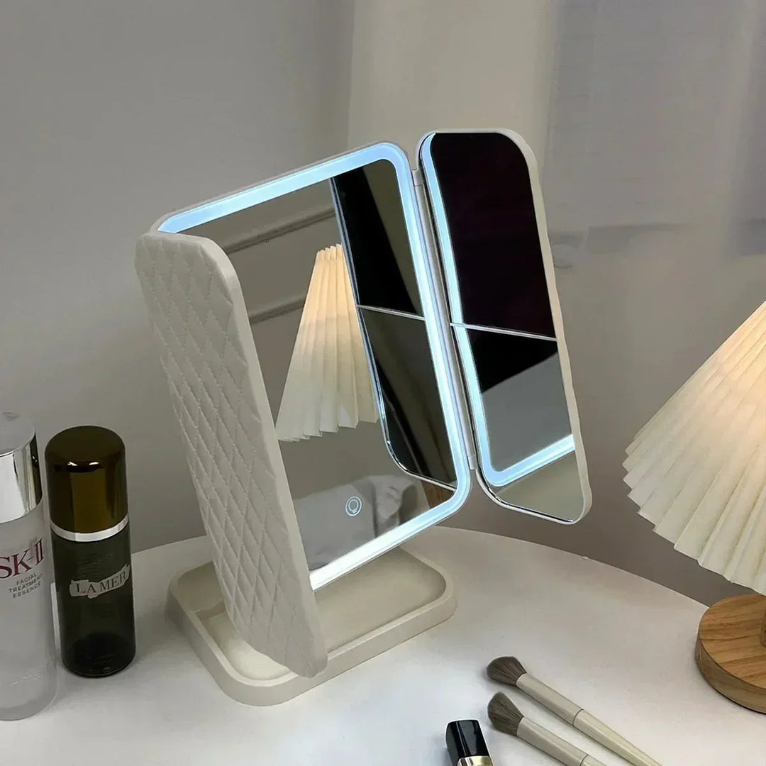 Clear view tri-fold LED makeup mirror with 3 light settings for flawless cosmetic application.
