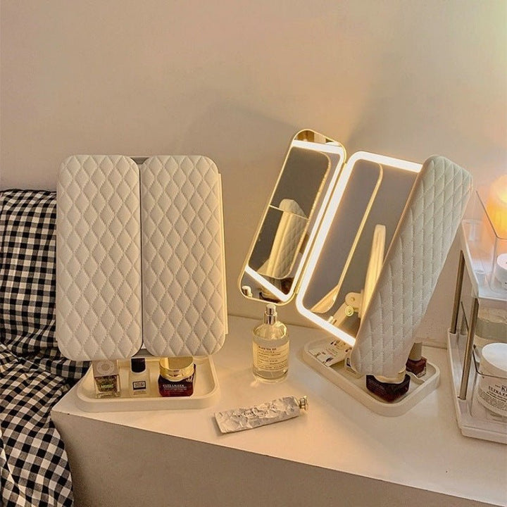 Compact desktop LED makeup mirror, tri-fold with 3 light settings, ideal for small spaces.