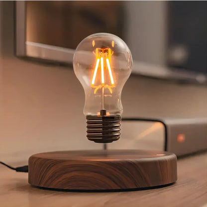 Floating LED light bulb with dark wood base, providing ambient modern lighting for any desk or home decor.