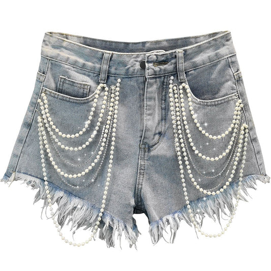 Light blue women's denim shorts with elegant pearl and playful tassel details, perfect for chic summer casual wear.