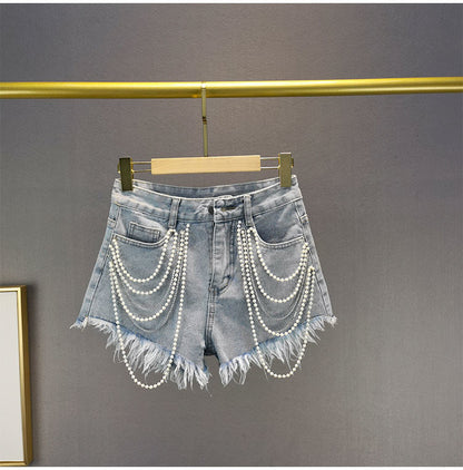 Trendy pearl tassel denim shorts for women, light blue, ideal for a stylish vacation outfit or summer fashion.