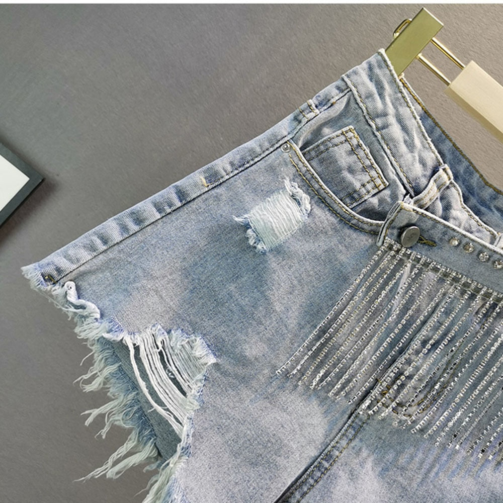 Versatile light blue women's shorts with sparkly diamond details, great for summer fashion and a chic ensemble.