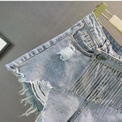 Versatile light blue women's shorts with sparkly diamond details, great for summer fashion and a chic ensemble.