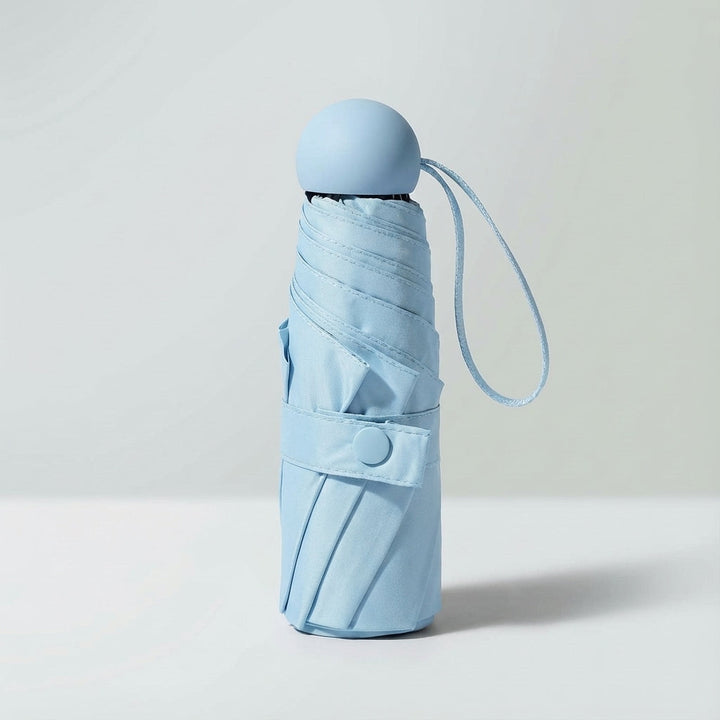 Ultra-compact light green windproof mini umbrella, ideal for bags & travel.