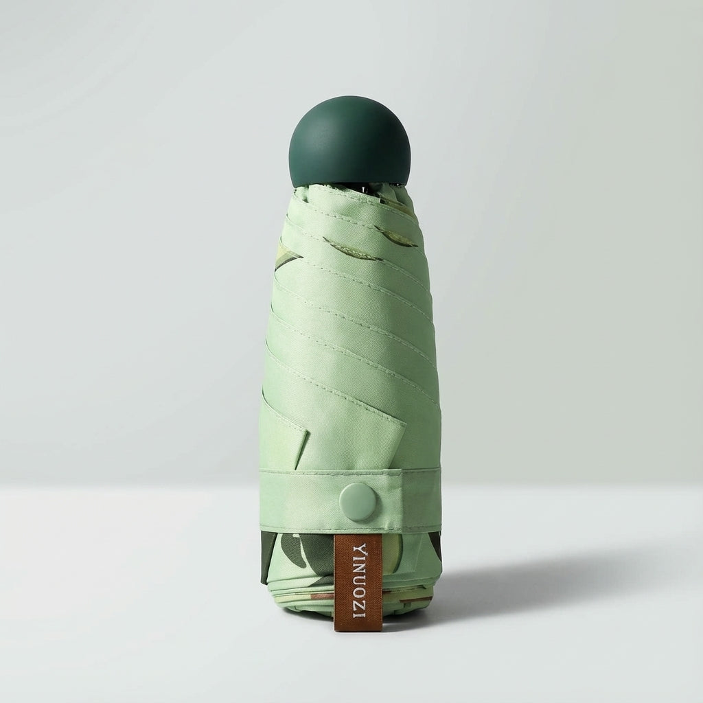 Unisex light green travel umbrella, mini & compact for on-the-go rain protection.