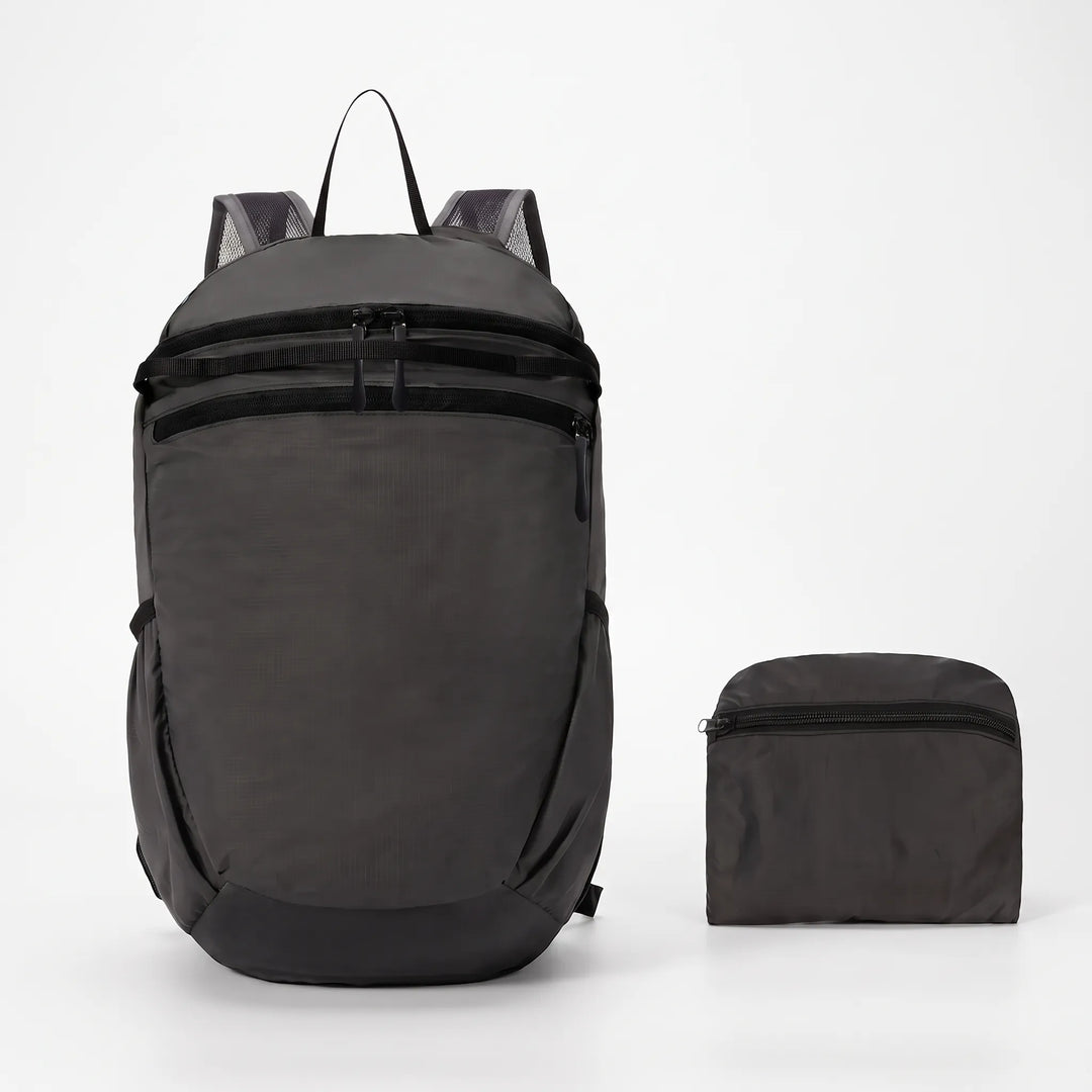 Compact & foldable hiking backpack in black, ideal for travelers seeking a lightweight outdoor daypack.