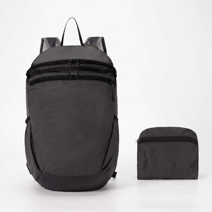 Compact & foldable hiking backpack in black, ideal for travelers seeking a lightweight outdoor daypack.