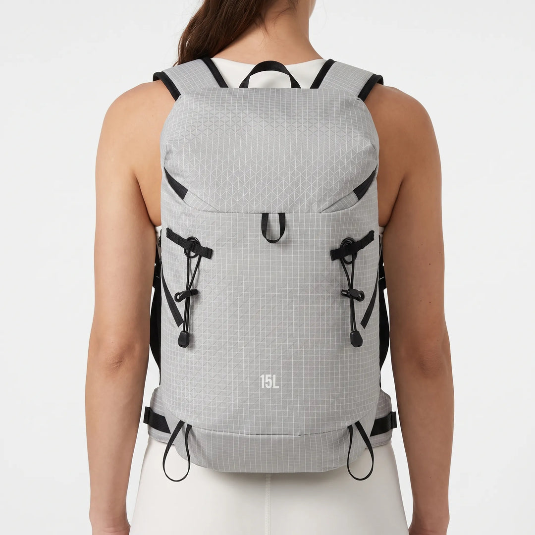 Unisex lightweight hydration backpack with multiple pockets for essential outdoor gear on trails.
