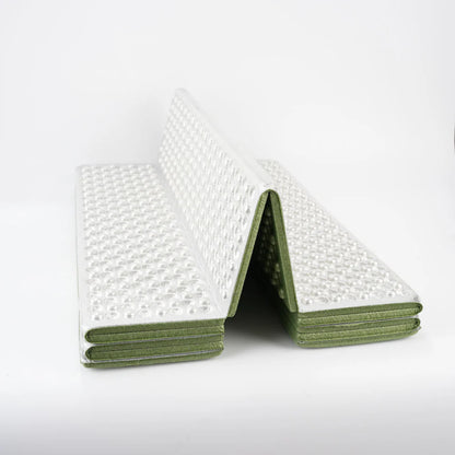 Unisex thermal sleeping pad in an outdoor camping shelter, showcasing its compact size