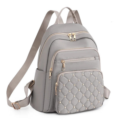 Black lightweight water-resistant nylon backpack for women, perfect for commuting & travel.